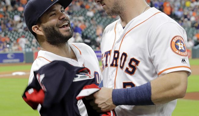 Houston Astros&#x27; Jose Altuve, left, jokes with Alex Bregman after they were presented their All-Star jerseys before a baseball game against the Oakland Athletics, Thursday, July 12, 2018, in Houston. (AP Photo/David J. Phillip)