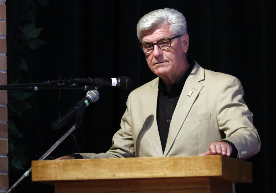 Gov. Phil Bryant speaks Saturday, July 14 2018 during ceremonies on the Mississippi Valley State University campus in Itta Bena, Miss., honoring the 15 Marines and a U.S. Navy corpsman who died in a July 10, 2017 plane crash near the school. A monument recognizing the military personnel, a state road recognition and a landmark marker detailing the history of the plane crash were unveiled. More than 200 relatives and friends of the 16 people who died aboard the flight with the call sign Yanky 72, joined a couple hundred county residents and military supporters at the ceremonies. (AP Photo/Rogelio V. Solis)
