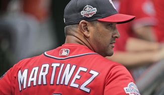 Washington Nationals manager Dave Martinez walks in the dugout before the start of a baseball game against the New York Mets at Citi Field, Sunday, July 15, 2018, in New York. (AP Photo/Seth Wenig)