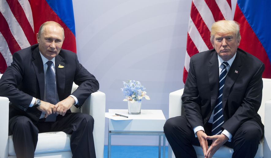 FILE - In this July 7, 2017, file photo, U.S. President Donald Trump, right, and Russian President Vladimir Putin pose for a photo during the G20 summit in Hamburg Germany. (AP Photo/Marcellus Stein, File)