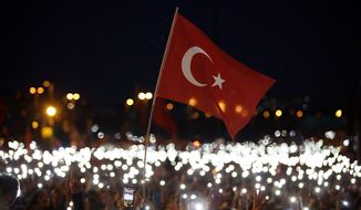 People use their mobile phones&#39; torches as they attend a commemoration event for the second anniversary of a botched coup attempt, in Istanbul, Sunday, July 15, 2018. Turkey commemorates the second anniversary of the July 15, 2016 failed military attempt to overthrow Turkey&#39;s President Recep Tayyip Erdogan with a series of events honouring some 250 people, who were killed across Turkey while trying to oppose coup-plotters.(AP Photo/Emrah Gurel)