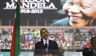 FILE -- In this Tuesday, Dec. 10, 2013, file photo, former U.S. President Barack Obama speaks to crowds attending the memorial service for former South African President Nelson Mandela, background, in Soweto, Johannesburg. In a speech marking the 100th birthday of anti-apartheid leader Nelson Mandela on Tuesday, July 17, 2018, former U.S. President Barack Obama will urge youth around the world to work for human rights and fair societies, highlighting the late South African leader&#39;s example of persevering in the struggle for democracy and equal rights for all. (AP Photo/Evan Vucci, File)