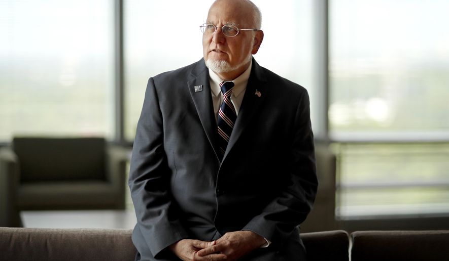 FILE - In this June 28, 2018, file photo, Dr. Robert Redfield Jr., director of the Centers for Disease Control and Prevention, poses at the agency's headquarters in Atlanta. The new head of the nation’s top public health agency says the U.S. opioid will be one of his main priorities, and it turns out there is a personal reason. (AP Photo/David Goldman, File)