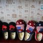 In this July 13, 2018, photo, Chinese made children shoes carrying a Chinese map and U.S. flags are on display for a sale at a shop in Beijing. China announced it filled a World Trade Organization challenge Monday, July 16, 2018,  to U.S. President Donald Trump&#39;s proposal for a tariff hike on $200 billion of Chinese goods, reacting swiftly amid deepening concern about the economic impact of their spiraling technology dispute. (AP Photo/Andy Wong)