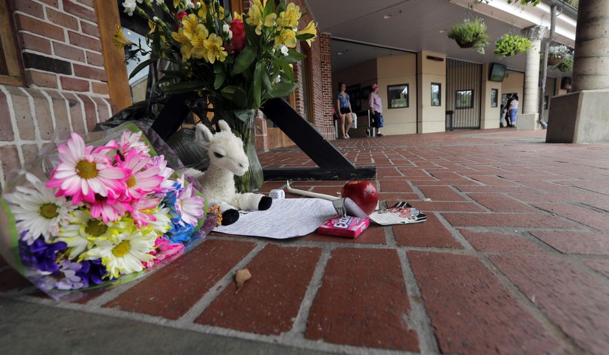 A makeshift memorial is seen outside the Audubon Zoo in New Orleans, Monday, July 16, 2018. The death of a wounded fox brings to nine the number of animals that have died as the result of the weekend escape of a jaguar from its enclosure at the zoo in New Orleans. Audubon Zoo officials say on the zoo's website that Rusty, one of two foxes attacked by the big cat, died Monday. (AP Photo/Gerald Herbert)