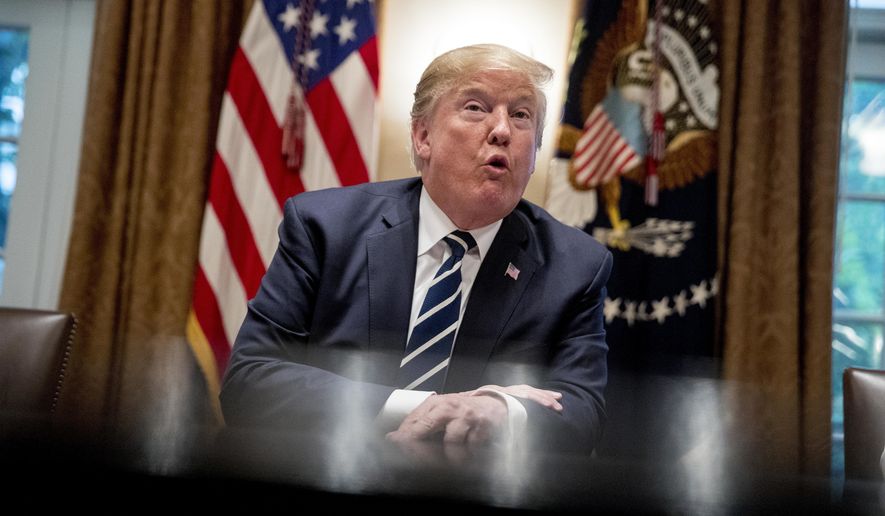 President Donald Trump speaks to members of the media as he meets with members of Congress in the Cabinet Room of the White House, Tuesday, July 17, 2018, in Washington. Trump says he meant the opposite when he said in Helsinki that he doesn't see why Russia would have interfered in the 2016 U.S. elections.(AP Photo/Andrew Harnik)