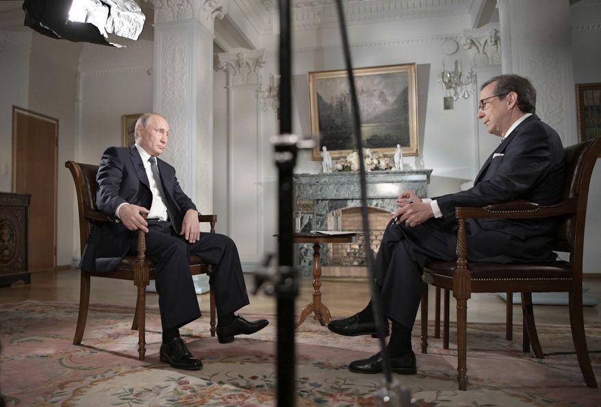 Russian President Vladimir Putin, left, gestures during an interview with "Fox News Sunday" host Chris Wallace after his meeting with U.S. President Donald Trump in Helsinki, Finland, Monday, July 16, 2018. (Alexei Nikolsky, Sputnik, Kremlin Pool Photo via AP)