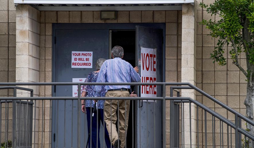 Voters make their way into the polling station at Aldersgate United Methodist Church in Montgomery, Ala., on for the runoff election, Tuesday, July 17, 2018. Rep. Martha Roby is facing Republican Bobby Bright on Tuesday. (Mickey Welsh/The Montgomery Advertiser via AP)