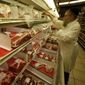 Rabbi Moishe Silverman stocks liver in a partially empty meat display at South Florida Kosher, a butcher shop in North Miami Beach, Fla., Tuesday, Nov. 25, 2008. (AP Photo/Wilfredo Lee)