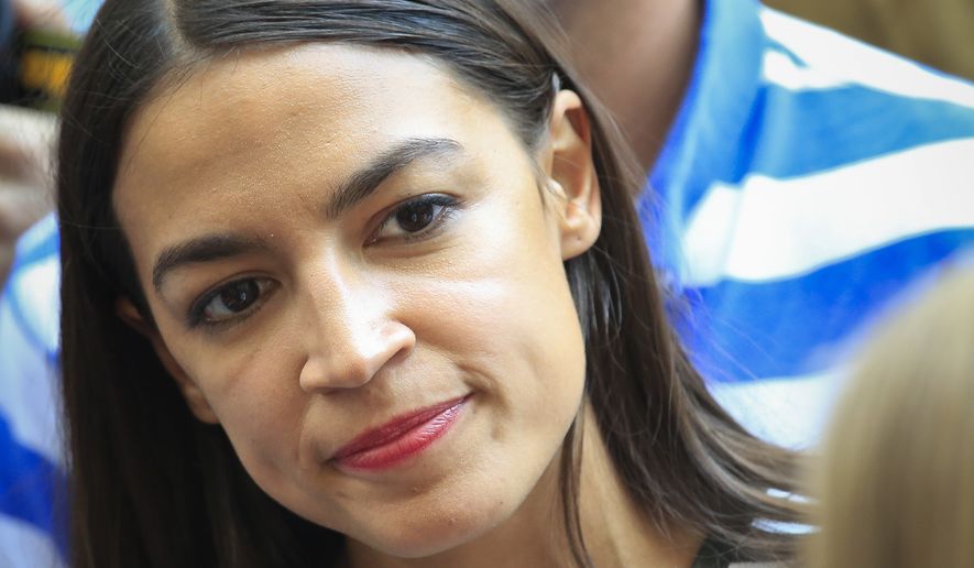 Alexandria Ocasio-Cortez, the surprise winner in the congressional race who unseated 20-year incumbent Joe Crowley in New York&#x27;s Congressional District 14, listens to Zephyr Teachout during a press conference, after endorsing her candidacy for Attorney General, Thursday, July 12, 2018, in New York. (AP Photo/Bebeto Matthews)