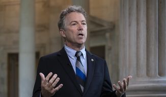 In this July 17, 2018, file photo, Sen. Rand Paul, R-Ky., speaks during a television interview as he defends President Donald Trump and his Helsinki news conference with Russian President Vladimir Putin on Capitol Hill in Washington. (AP Photo/J. Scott Applewhite)