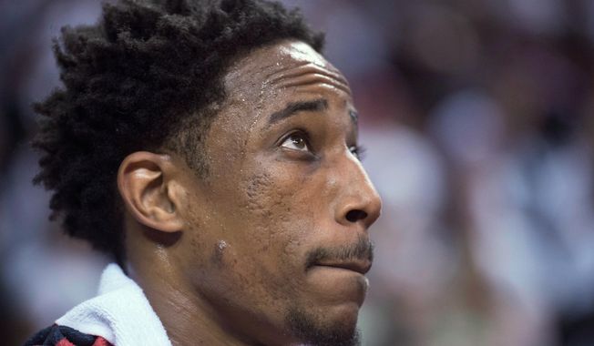 FILE - In this April 25, 2018, file photo, Toronto Raptors&#x27; DeMar DeRozan looks up at the scoreboard late in the second against the Washington Wizards in Game 5 of an NBA basketball first-round playoff series, in Toronto. Two people familiar with the situation say San Antonio and Toronto have reached an agreement in principle on a trade that will send Kawhi Leonard to the Raptors and DeMar DeRozan to the Spurs. One of the people says the Spurs also are sending Danny Green to the Raptors as part of the deal. Both people spoke to The Associated Press on condition of anonymity Wednesday, July 18, 2018, because the deal has not been finalized. (Frank Gunn/The Canadian Press via AP, File)
