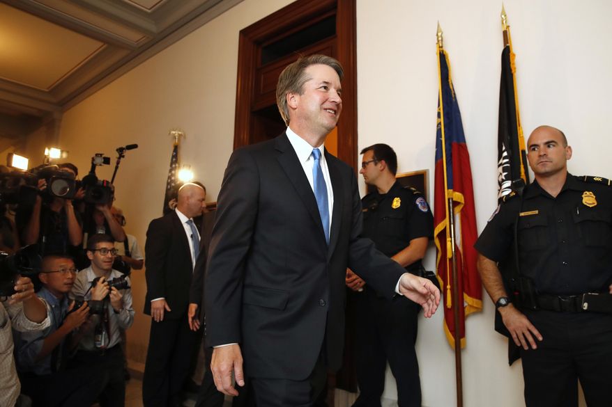Supreme Court nominee Judge Brett Kavanaugh, center, walks to the office of Sen. Johnny Isakson, R-Ga., for a meeting Tuesday, July 17, 2018, on Capitol Hill in Washington. (AP Photo/Jacquelyn Martin)