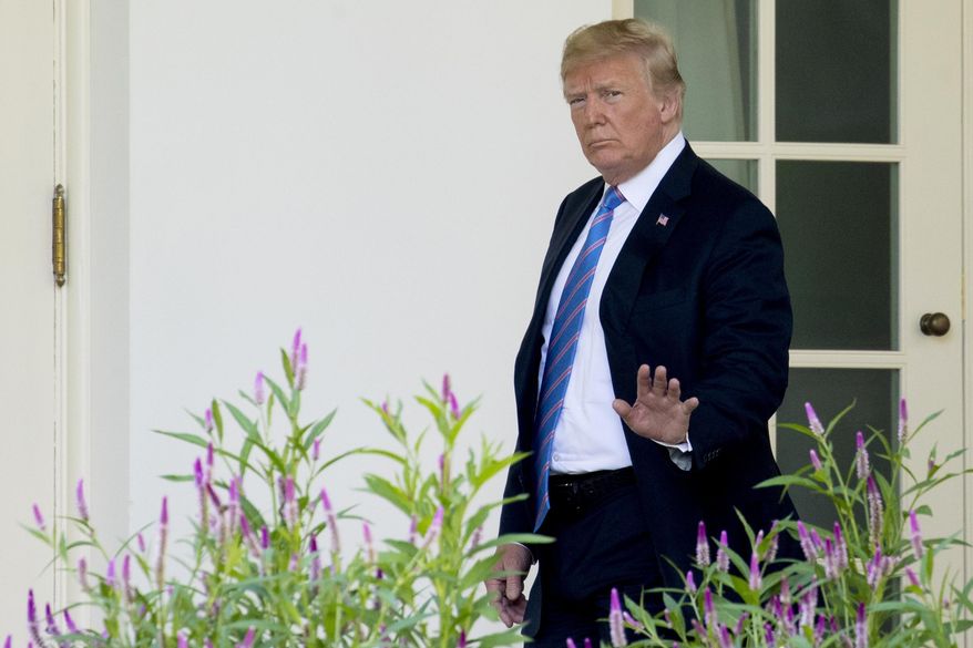 President Donald Trump waves to members of the media as he walks towards the West Wing of the White House in Washington, Wednesday, July 18, 2018, after returning from Andrews Air Force Base, and paying respects to the family of fallen U.S. Secret Service special agent Nole Edward Remagen who suffered a stroke while on duty in Scotland. (AP Photo/Andrew Harnik)
