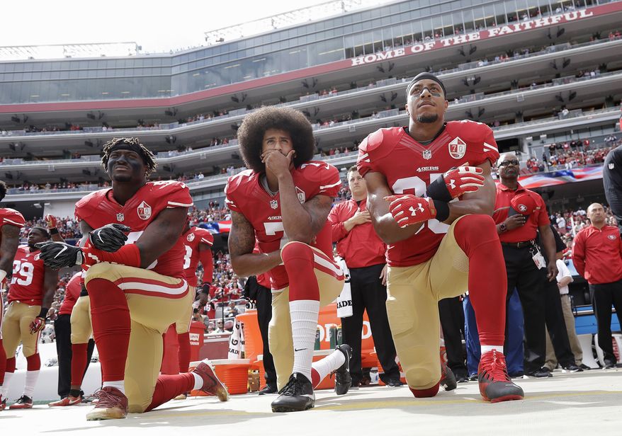 FILE - In this Oct. 2, 2016 file photo, from left, San Francisco 49ers outside linebacker Eli Harold, quarterback Colin Kaepernick and safety Eric Reid kneel during the national anthem before an NFL football game against the Dallas Cowboys in Santa Clara, Calif. In recent months, Colin Kaepernick has become comfortable with people knowing him as more than a laser-focused football player as he always previously preferred it. Perhaps, through the anthem protest and his emergence as an outspoken activist for minorities, Kaepernick has improved his image in the process. (AP Photo/Marcio Jose Sanchez, File)