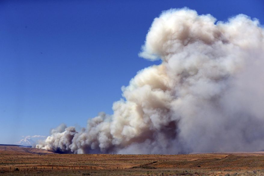 A fast-moving fire continues to rage across Wasco County southeast of The Dalles, Ore., Wednesday, July 18, 2018. The deadly fire reached 36,000 acres Wednesday, July 18, 2018. The blaze Wednesday doesn't bode well for a Pacific Northwest fire season that's expected to be worse than normal. The region has seen drought conditions in many areas. (Mark Graves/The Oregonian via AP)