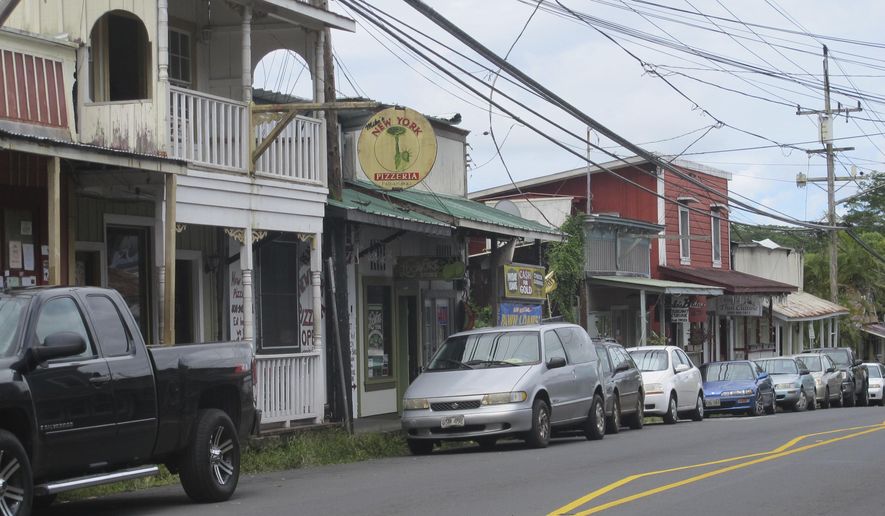 FILE - This Sept. 8, 2014 file photo shows downtown Pahoa, Hawaii. The small, rural town of Pahoa is the gateway to the eruption pouring rivers of lava out of Hawaii&#x27;s Kilauea volcano. Historic wooden buildings lining its main street are just a few miles from where a cinder cone shooting lava into the sky has popped up in people&#x27;s yards. Tourism to parts of the island has plummeted since the volcano began erupting in a residential neighborhood and burning down homes in May. (AP Photo/Audrey McAvoy, File)