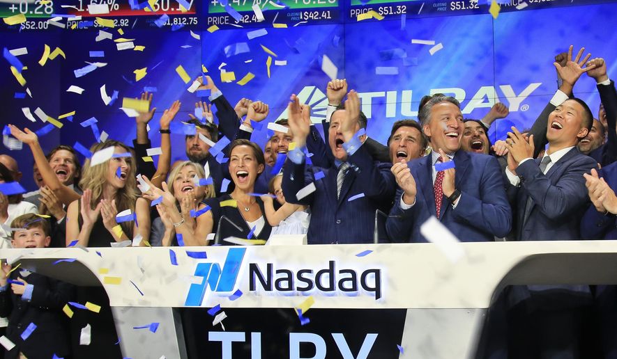 Brendan Kennedy, third from right in front, CEO and founder of British Columbia-based Tilray Inc., a major Canadian marijuana grower, leads cheers as confetti falls to celebrate his company&#39;s IPO (TLRY) at Nasdaq, Thursday, July 19, 2018, in New York. Medical marijuana is legal in Canada, and on Oct. 17, the country will become the first major industrialized nation to legalize its production and sale for recreational use. (AP Photo/Bebeto Matthews)