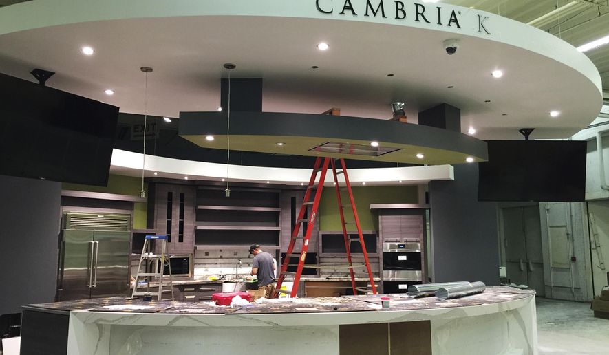 This July 2018 photo provided by the Minnesota State Fair shows workers putting finishing touches on the the state-of-the-art Cambria Kitchen, a new food attraction for 2018 in the Creative Activities building at the Minnesota State Fair in St. Paul, Minn. A full schedule of local chefs and demonstrators will include Andrew Zimmern of &amp;quot;Bizarre Foods&amp;quot; fame and Sean Sherman &amp;amp; The Sioux Chef&#x27;s Indigenous Food Lab, with a fresh take on Native American cuisine. (Minnesota State Fair via AP)