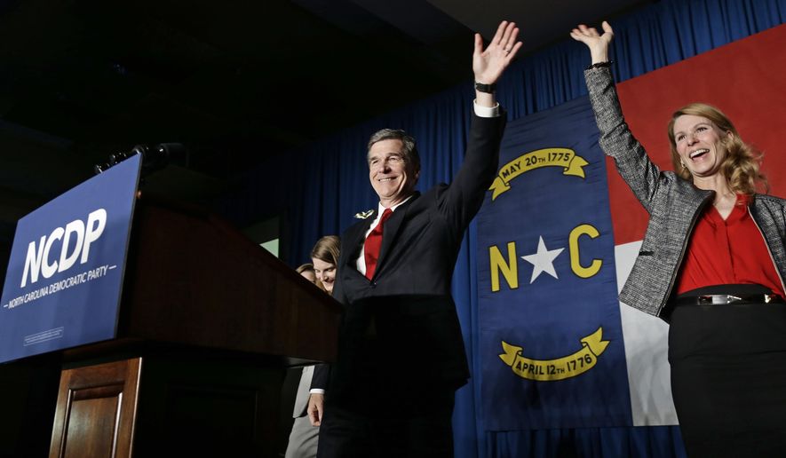 In this Nov. 9, 2016, file photo, North Carolina Democratic candidate for governor Roy Cooper and his wife Kristin greet supporters during an election night rally in Raleigh, N.C. In closely divided North Carolina, an intense power struggle between Republican lawmakers and Cooper will spill over to voting booths this fall. (AP Photo/Gerry Broome, File)