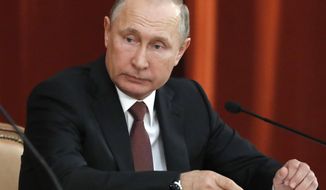 Russian Vladimir Putin attends a meeting with Russian ambassadors to foreign countries in Moscow, Russia, Thursday, July 19, 2018. Putin says his first summit with U.S. President Donald Trump was &amp;quot;successful&amp;quot; and is accusing Trump&#39;s opponents in the U.S. of hampering any progress on the issues they discussed. (Sergei Karpukhin/Pool Photo via AP)