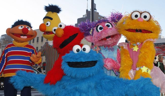 FILE - In this Feb. 10, 2010, file photo, characters from Sesame Street Live appear on the street by Madison Square Garden to celebrate the 30th anniversary of the live touring stage shows based on the PBS television series. in New York. From left are Ernie, Bert, Elmo, Cookie Monster (foreground), Abby Cadabby, and Zoe. The Sesame Street company is taking its beloved, critically-acclaimed brand of educational television into the highly profitable world of classroom curriculum. It's a move that experts say could open the door for other companies to sink their teeth into a sacred learning space. Sesame Workshop and McGraw-Hill Education announced their new partnership Thursday, July 19, 2018. (AP Photo/Kathy Willens, File)