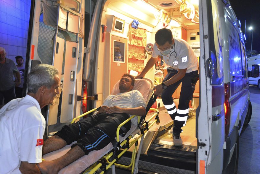 Paramedics carry a person rescued from a boat that capsized off Cyprus&#39; northern coastline, as he is brought to a hospital in Silifke, near the city of Mersin, southern Turkey, late Wednesday, July 18, 2018.  A boat carrying about 150 migrants capsized off the northern coast of Cyprus on Wednesday, with the search continuing and some 105 people rescued so far according to the Turkish coast guard. (Mustafa Ercan/DHA-Depo Photos via AP)