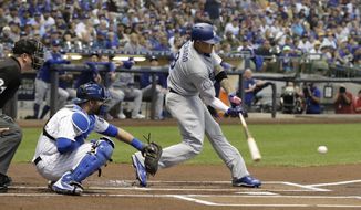 Los Angeles Dodgers&#39; Manny Machado hits a single during the first inning of a baseball game against the Milwaukee Brewers Friday, July 20, 2018, in Milwaukee. (AP Photo/Morry Gash)