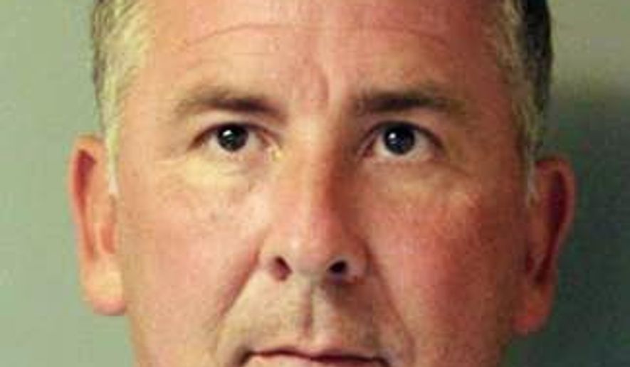 This is a mugshot provided by the Delaware Department of Justice of John C. Atkins, a former state legislator. Court records show that the 48-year-old Atkins of Millsboro was arrested last week and charged with strangulation, a felony, and third-degree assault, which is a misdemeanor. He was given a $7,000 unsecured bond. (Delaware Department of Justice via AP)