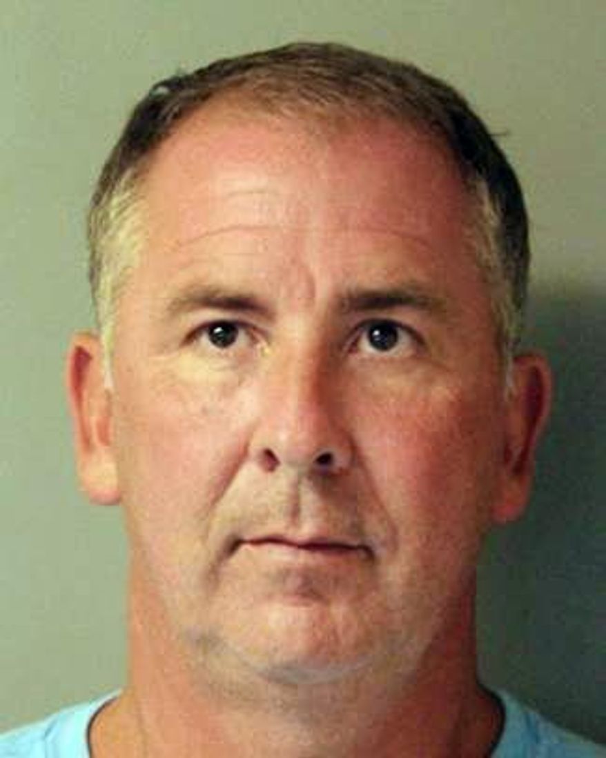 This is a mugshot provided by the Delaware Department of Justice of John C. Atkins, a former state legislator. Court records show that the 48-year-old Atkins of Millsboro was arrested last week and charged with strangulation, a felony, and third-degree assault, which is a misdemeanor. He was given a $7,000 unsecured bond. (Delaware Department of Justice via AP)