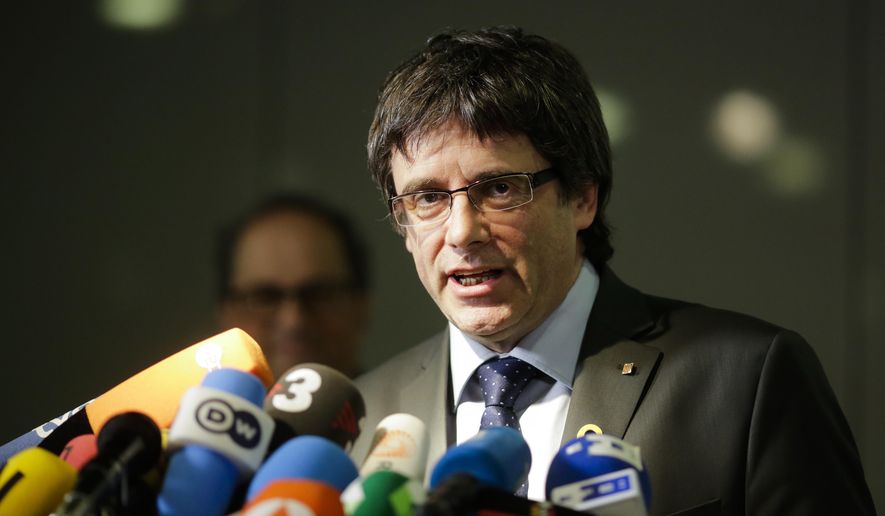 FILE - In this May 15, 2018 file photo former Catalan leader, Carles Puigdemont, addresses the media during a news conference in Berlin, Germany. A Spanish Supreme Court judge has dropped his extradition requests for six Catalan separatist politicians wanted on rebellion charges.  (AP Photo/Markus Schreiber, file)