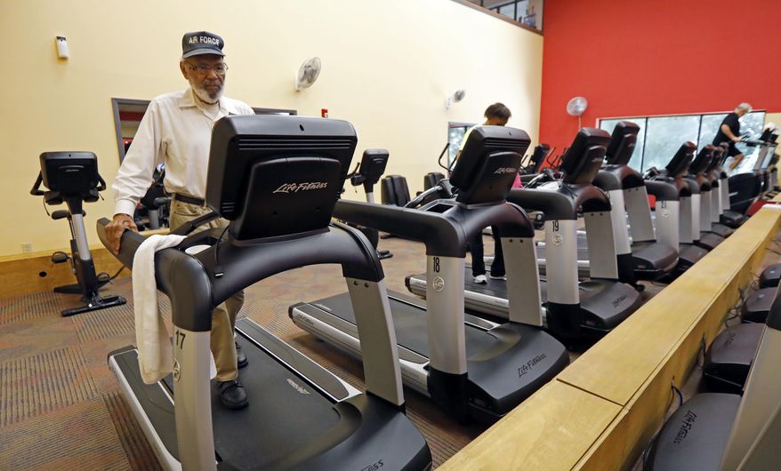 James Meredith walks on a treadmill at least 30 minutes as part of his morning workout at a fitness center in Flowood, Miss., Thursday, July 19, 2018. (AP Photo/Rogelio V. Solis)
