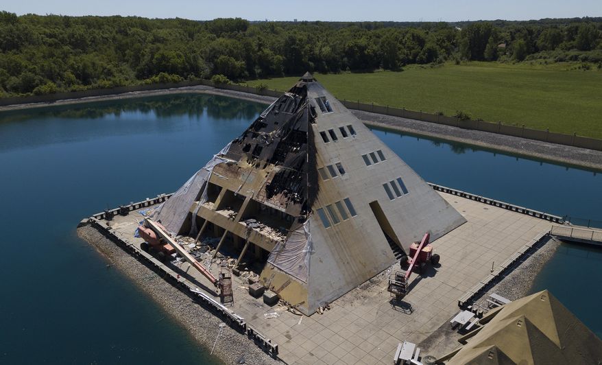 This aerial photo shows fire damage to the Golf Pyramid House Wednesday, July 18, 2018, in Wadsworth, Ill. Fire officials say no people were hurt but a dog died in the Tuesday fire. The Gold Pyramid House was built in 1977 as a private residence but has since opened for public tours. (Mark Welsh/Daily Herald via AP)