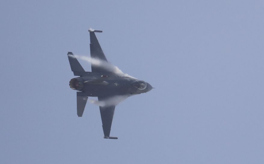 A U.S. Air Force F-16 fighter jet flies over Osan Air Base during a media preview of Air Power Day in Pyeongtaek, South Korea, Friday, Sept. 23, 2016. The U.S. and South Korea Air Force demonstration teams will participate in the air show which will be held on Sept. 24 and 25. (AP Photo/Lee Jin-man)