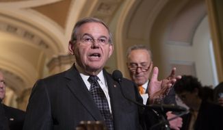 Sen. Bob Menendez, D-N.J., the ranking member of the Senate Foreign Relations Committee, joined at right by Senate Minority Leader Chuck Schumer, D-N.Y., talks to reporters on Capitol Hill in Washington, Tuesday, June 12, 2018. (AP Photo/J. Scott Applewhite) ** FILE **