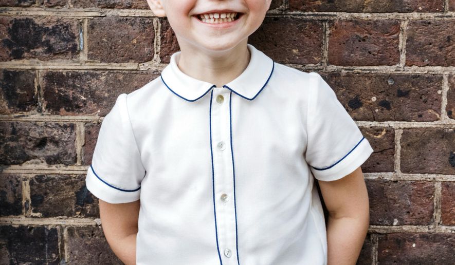 In this photo taken on Monday, July 9, 2018, Britain's Prince George poses for a picture following the christening of his brother Prince Louis, at Clarence House in London. Britain's Prince William and Kate, Duchess of Cambridge have released a photo of Prince George to mark his fifth birthday on Sunday, July 22. (Matt Porteous via AP)