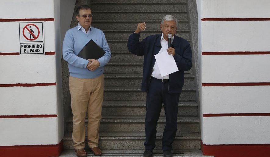 Mexico's President-elect Andres Manuel Lopez Obrador, right, and his future Foreign Minister, Marcelo Ebrard, speaks to the press outside his party's headquarters in Mexico City, Sunday, July 22, 2018. Lopez Obrador has released a seven-page letter he sent to U.S. President Donald Trump earlier in July detailing how he sees the two countries working together to stem immigration. (AP Photo/Marco Ugarte)