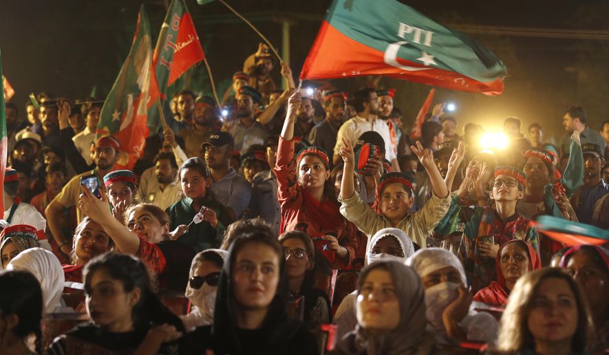 Supporters of Tehreek-e-Insaf party greet to their leader Imran Khan during an election campaign rally in Islamabad, Pakistan, Saturday, July 21, 2018. Pakistan will hold general election on July 25. (AP Photo/Anjum Naveed)