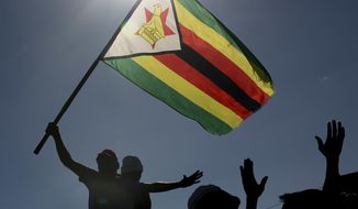 Thousands of opposition party supporters cheer leading opposition challenger Nelson Chamisa during a rally in Bulawayo, Zimbabwe, Saturday July 21, 2018. Just 3 percentage points now separate Chamisa and former Mugabe deputy and current President Emmerson Mnangagwa ahead of the July 30 presidential vote, according to a new survey by the Afrobarometer research group. (AP Photo/Jerome Delay)