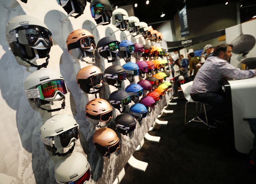 Ski helmets line a wall in the Smith booth at the Outdoor Retailer and Snow Show in the Colorado Convention Center Friday, Jan. 26, 2018, in Denver. Sales of outdoor equipment are slipping as millennials drive changes in U.S. consumer habits by favoring clothes and sporting goods that are less specialized and more versatile, analysts say. (AP Photo/David Zalubowski)