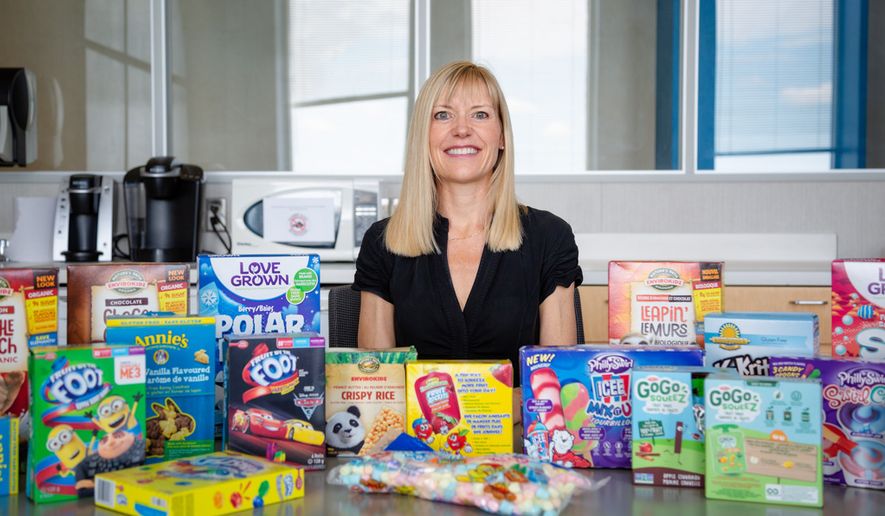 Charlene Elliott, research chair in food marketing, policy and children's health at the University of Calgary, shows some popular children's food that was evaluated in her recent study looking into comparisons of gluten-free food aimed at kids. (Courtesy Debby Herold/Faculty of Arts/University of Calgary)