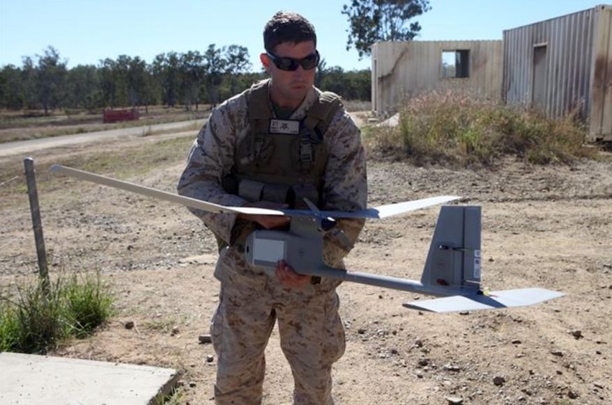 An assistant intelligence officer with Battalion Landing Team 2nd Battalion, 1st Marines, 31st Marine Expeditionary Unit, holds a RQ-11B Raven unmanned aerial vehicle in July 2012. (Image: U.S. Marine Corps, Cpl. Jonathan Wright) ** FILE **