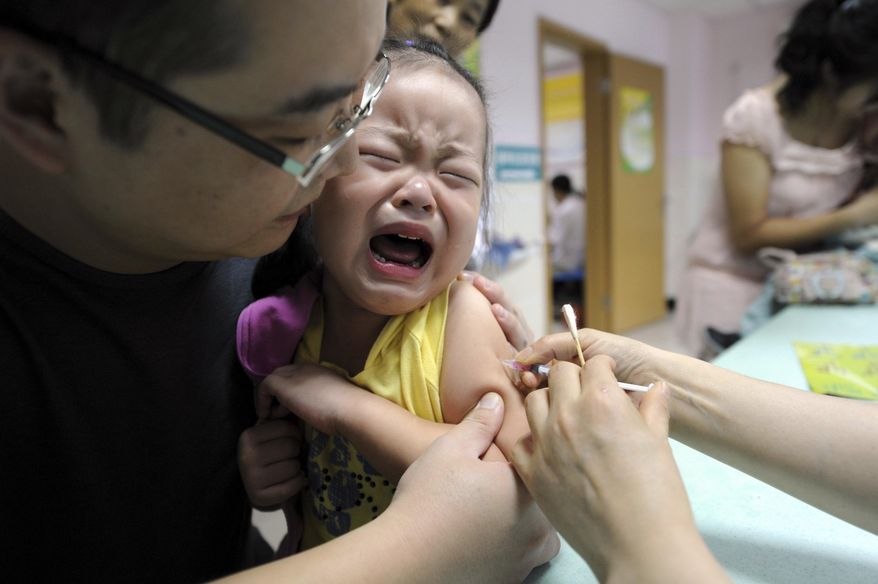 A child cries while receiving a shot of measles vaccine at a health station. (Chinatopix via AP)
