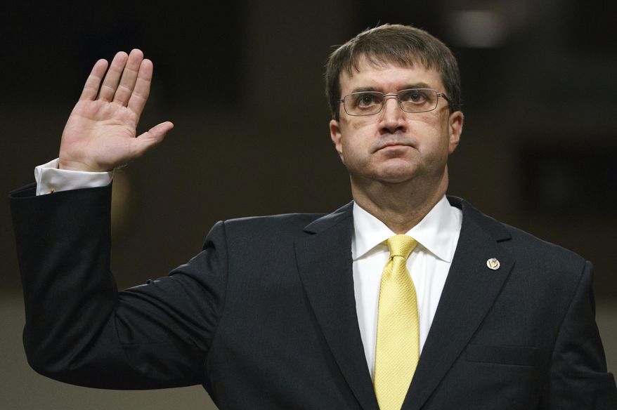 FILE - In a Wednesday, June 27, 2018 file photo, Veterans Affairs Secretary nominee Robert Wilkie is sworn in at the start of a Senate Veterans Affairs Committee nominations hearing on Capitol Hill in Washington. Wilkie is expected to become secretary of Veterans Affairs when the Senate votes Monday, July 23 to confirm him. (AP Photo/Carolyn Kaster, File)
