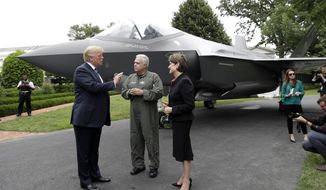 In this July 23, 2018, file photo, President Donald Trump talks with Lockheed Martin president and CEO Marilyn Hewson and director and chief test pilot Alan Norman in front of a F-35 as he participates in a &quot;Made in America Product Showcase&quot; at the White House in Washington. On Oct. 28, 2019, the Pentagon and Lockheed Martin on completed a $34 billion deal that will result in the delivery of 478 F-35 Lightning II fighter jets. (AP Photo/Evan Vucci) **FILE**