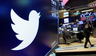 In this Feb. 8, 2018, file photo, the logo for Twitter is displayed above a trading post on the floor of the New York Stock Exchange. (AP Photo/Richard Drew, File)