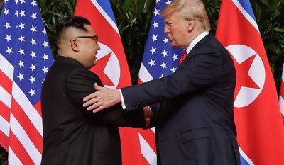 In this Tuesday, June 12, 2018, photo, U.S. President Donald Trump shakes hands with North Korea leader Kim Jong-un at the Capella resort on Sentosa Island in Singapore. Mr. Trump has already met twice with Russian President Vladimir Putin, but he is eager to re-create in Finland the heady experience that he had last month with Mr. Jong-un. That Singapore summit became a mass media event complete with powerful presidential images. (AP Photo/Evan Vucci, File)