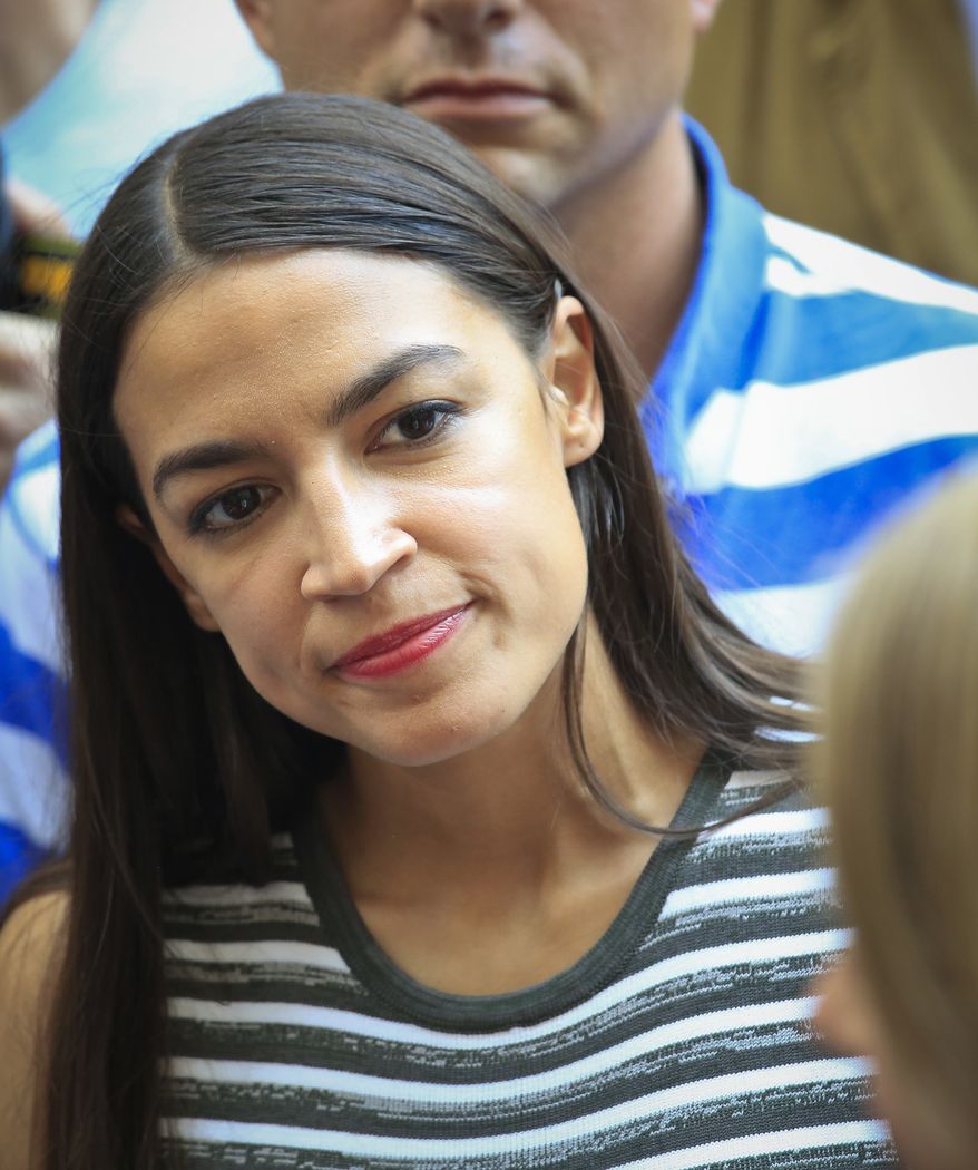Alexandria Ocasio-Cortez, the surprise winner in the congressional race who unseated 20-year incumbent Joe Crowley in New York's Congressional District 14, listens to Zephyr Teachout during a press conference, after endorsing her candidacy for Attorney General, Thursday, July 12, 2018, in New York. (AP Photo/Bebeto Matthews)