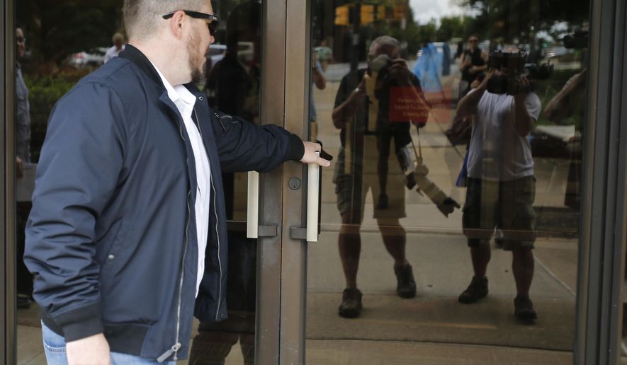 White Nationalist Jason Kessler arrives at Federal court 45 minutes late for a hearing on his rally permit in Charlottesville, Va., Tuesday, July 24, 2018. Kessler, an organizer of last summer&#39;s deadly white nationalist rally in Virginia, has withdrawn his request for a court order allowing him to stage an event marking the rally&#39;s anniversary. (AP Photo/Steve Helber)