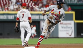 St. Louis Cardinals&#x27; Dexter Fowler runs home to score on a double by Yairo Munoz off Cincinnati Reds starting pitcher Homer Bailey during the seventh inning of a baseball game, Tuesday, July 24, 2018, in Cincinnati. (AP Photo/John Minchillo)